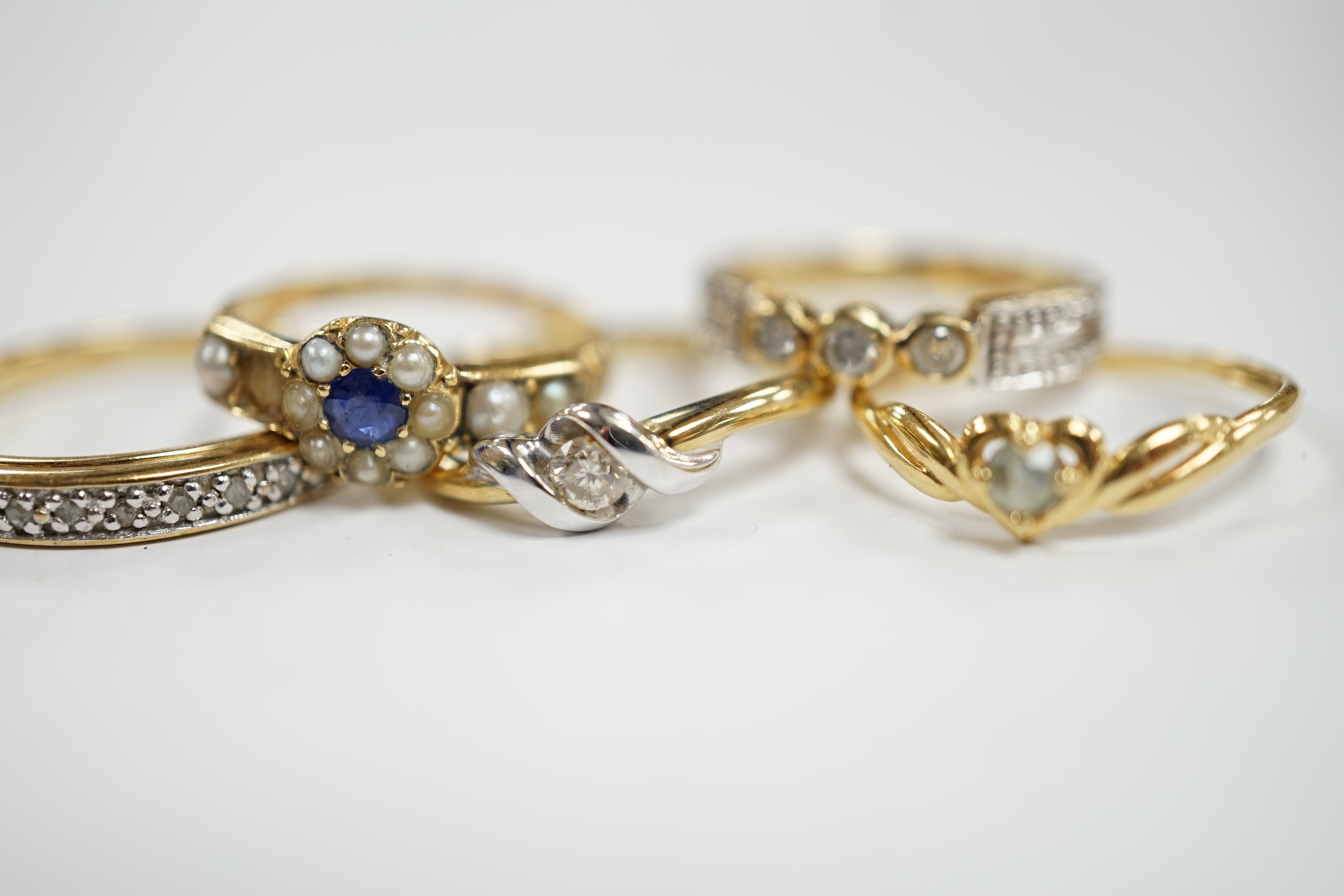 Three assorted modern 9ct gold and diamond set rings, gross 6.5 grams and two other yellow metal and gem set rings.